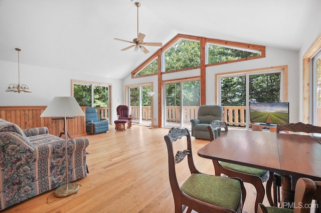 8413 Gay Park Rd, Lake Linden, MI 49945 - dining space with a ceiling fan, wood finished floors, high vaulted ceiling, and a chandelier