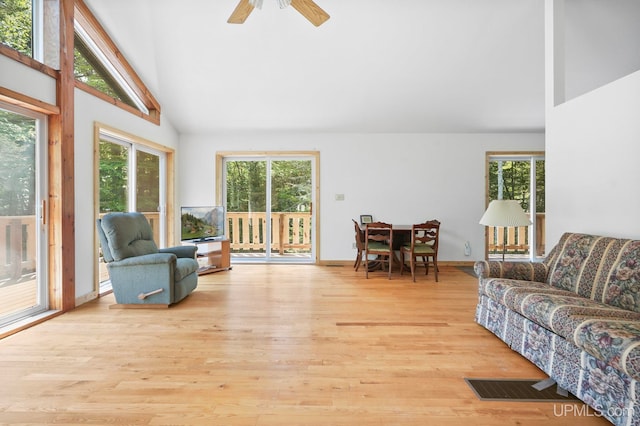 8413 Gay Park Rd, Lake Linden, MI 49945 - living area with plenty of natural light, light wood finished floors, high vaulted ceiling, and a ceiling fan