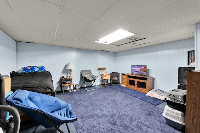 3582 David K Dr, Waterford, MI 48329 - carpeted bedroom with a drop ceiling and a wood stove