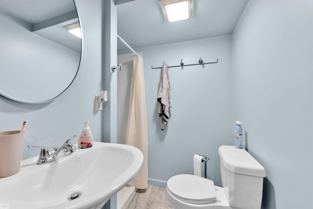 3582 David K Dr, Waterford, MI 48329 - bathroom with a sink, toilet, a shower with curtain, and baseboards
