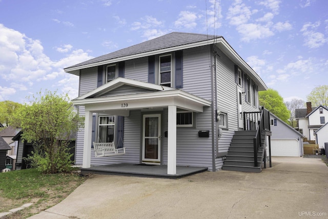 120 E Prospect St, Marquette, MI 49855 - american foursquare style home featuring a porch, an outbuilding, and a detached garage