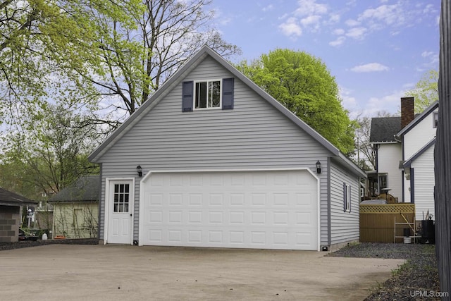 120 E Prospect St, Marquette, MI 49855 - view of side of property with an outbuilding, a garage, and concrete driveway