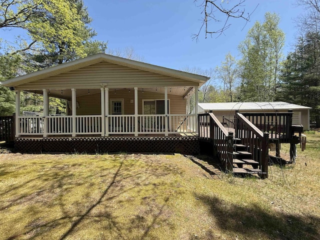 631 Rivers Terrace St, Gladwin, MI 48624 - view of front of house with covered porch and a front lawn