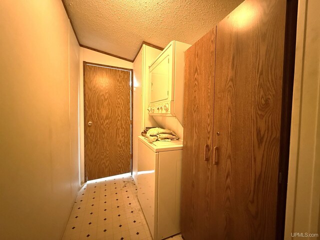 20 Kenneally Blvd St, Gladstone, MI 49837 - laundry room with estacked washer and dryer, light floors, and a textured ceiling