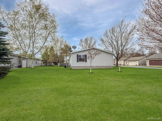 20 Kenneally Blvd St, Gladstone, MI 49837 - view of green lawn with central air condition unit