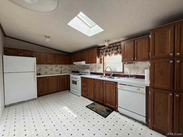 20 Kenneally Blvd St, Gladstone, MI 49837 - kitchen with white appliances, a sink, a skylight, light countertops, and under cabinet range hood