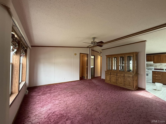 20 Kenneally Blvd St, Gladstone, MI 49837 - unfurnished living room with ceiling fan, crown molding, a textured ceiling, and carpet flooring
