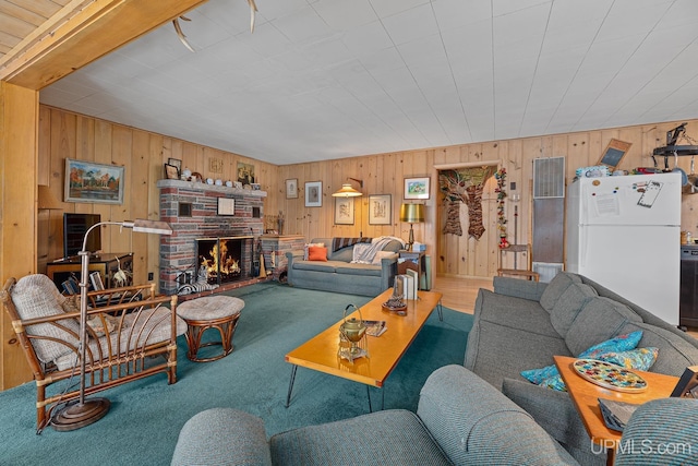 3172 Harry Patterson Dr, Phelps, WI 54554 - carpeted living room with wooden walls and a brick fireplace