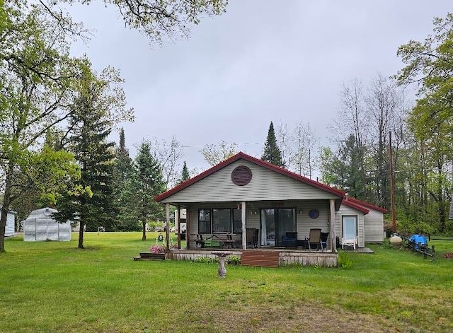 6257 Swallow Dr, Harrison, MI 48625 - rear view of house with a lawn