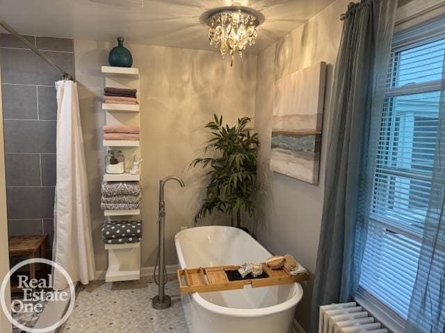 28800 Old N River Rd, Harrison Twp, MI 48045 - full bathroom featuring radiator heating unit, a freestanding tub, a chandelier, and baseboards