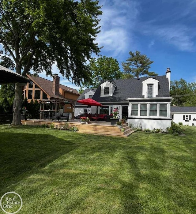 28800 Old N River Rd, Harrison Twp, MI 48045 - rear view of house featuring a deck, a yard, roof with shingles, and a chimney