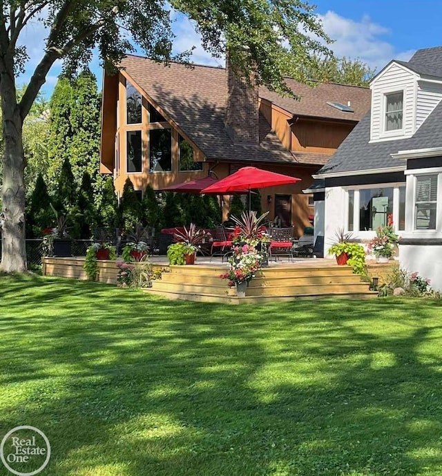 28800 Old N River Rd, Harrison Twp, MI 48045 - back of house featuring a wooden deck, a chimney, a shingled roof, and a lawn