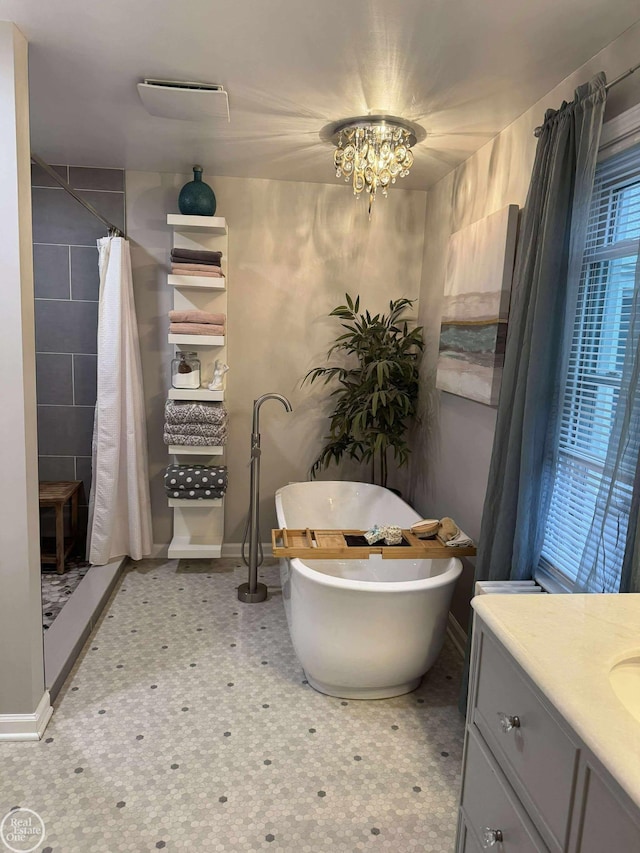 28800 Old N River Rd, Harrison Twp, MI 48045 - bathroom featuring tiled shower, vanity, baseboards, and a freestanding bath