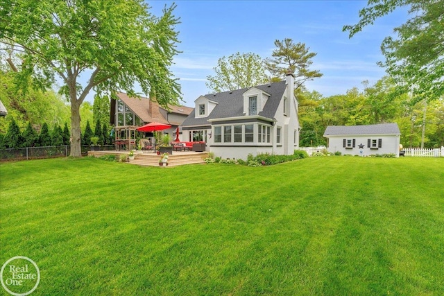 28800 Old N River Rd, Harrison Twp, MI 48045 - back of house featuring a deck, a chimney, and an outdoor structure