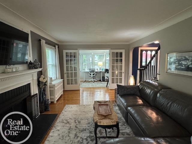 28800 Old N River Rd, Harrison Twp, MI 48045 - living area with french doors, wood finished floors, a fireplace, and ornamental molding