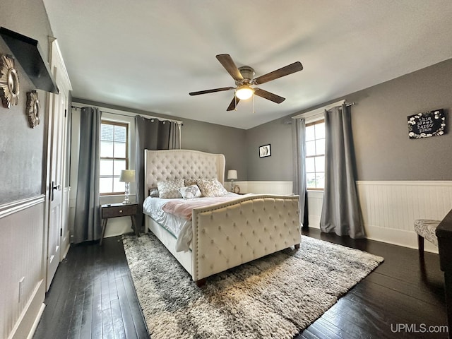 1217 S Kimberly Ave, Iron Mountain, MI 49801 - bedroom featuring dark wood finished floors, wainscoting, and ceiling fan