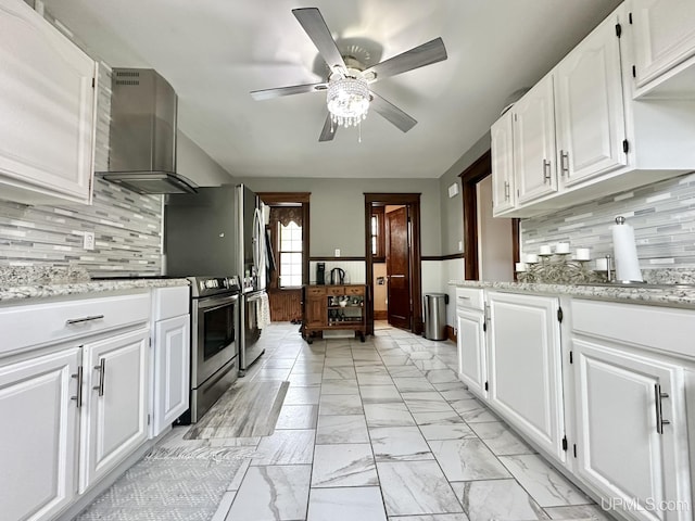 1217 S Kimberly Ave, Iron Mountain, MI 49801 - kitchen featuring wall chimney exhaust hood, stainless steel electric range oven, light marble finish flooring, a ceiling fan, and white cabinets