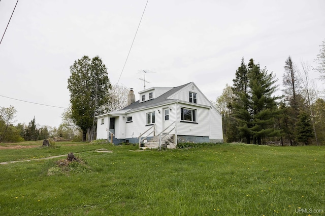 3110 County Road Fd Rd, Champion, MI 49814 - back of house featuring entry steps, a chimney, and a lawn