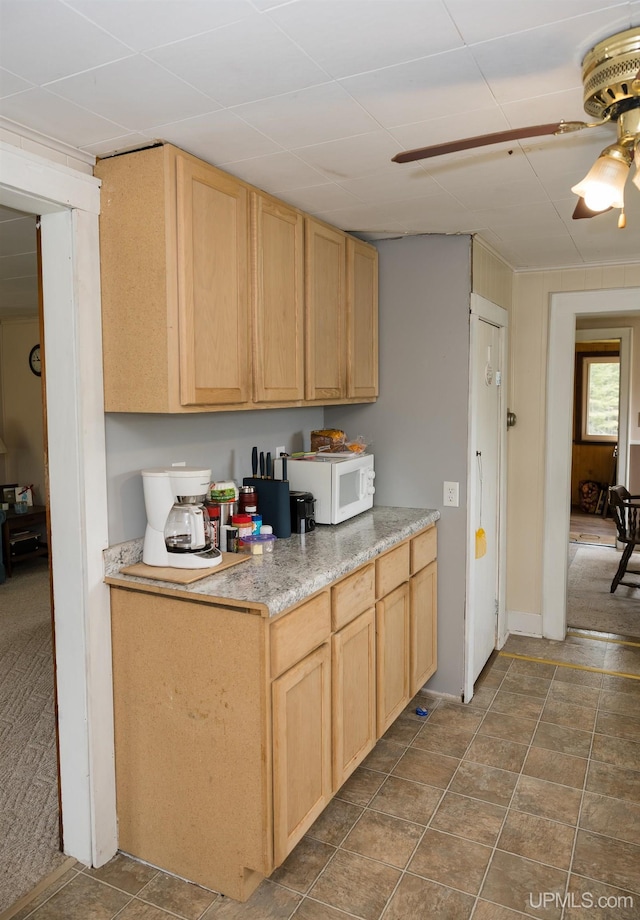 3110 County Road Fd Rd, Champion, MI 49814 - kitchen with light brown cabinetry, white microwave, ceiling fan, and light countertops
