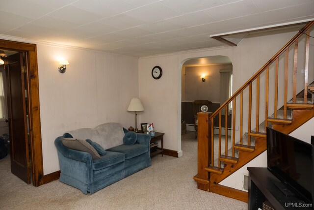 3110 County Road Fd Rd, Champion, MI 49814 - living room featuring arched walkways, carpet floors, stairs, baseboards, and ornamental molding