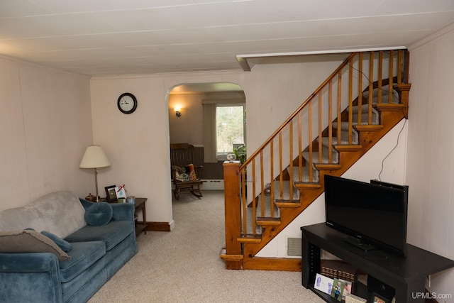 3110 County Road Fd Rd, Champion, MI 49814 - living area featuring carpet flooring, arched walkways, stairway, ornamental molding, and baseboard heating