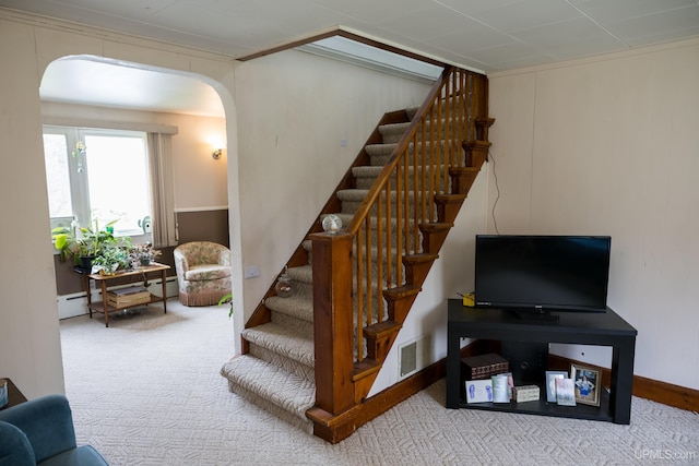 3110 County Road Fd Rd, Champion, MI 49814 - stairway with arched walkways, carpet floors, and a baseboard heating unit