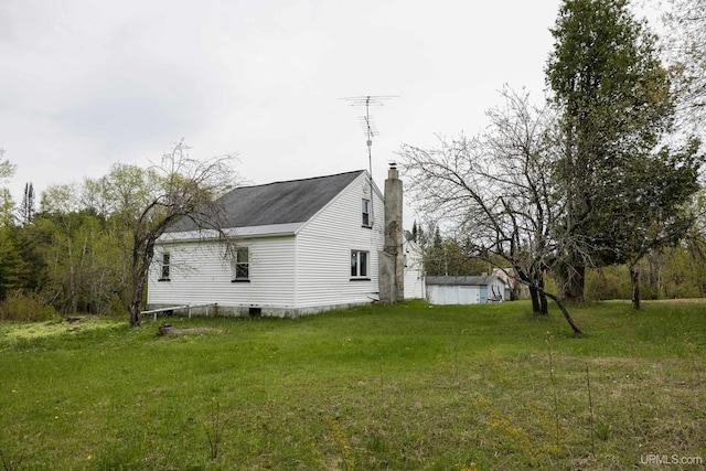 3110 County Road Fd Rd, Champion, MI 49814 - view of side of property featuring a chimney and a lawn