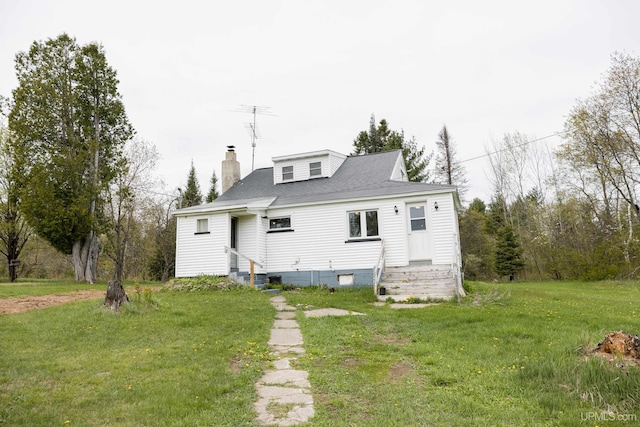 3110 County Road Fd Rd, Champion, MI 49814 - rear view of house with a chimney, a yard, and entry steps