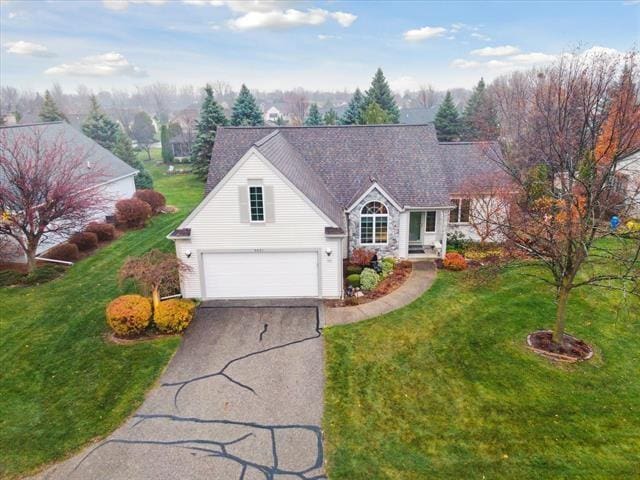 5631 W Spring Knoll Dr, Bay City, MI 48706 - traditional home with driveway, a front lawn, and an attached garage