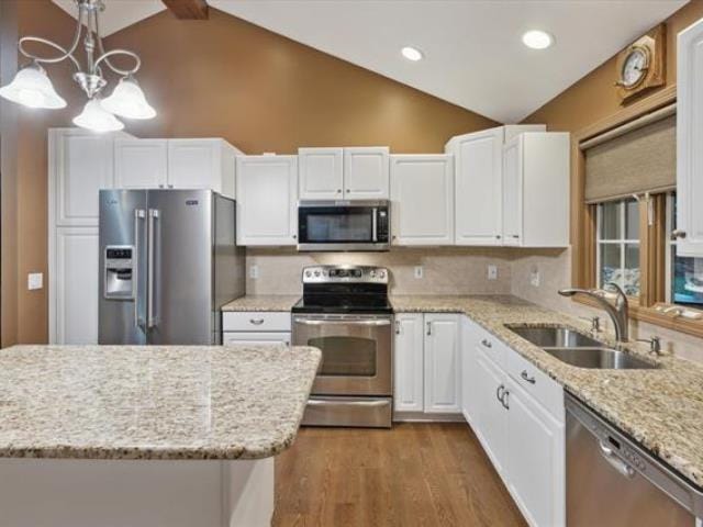 5631 W Spring Knoll Dr, Bay City, MI 48706 - kitchen featuring stainless steel appliances, a sink, white cabinetry, dark wood-type flooring, and light stone counters