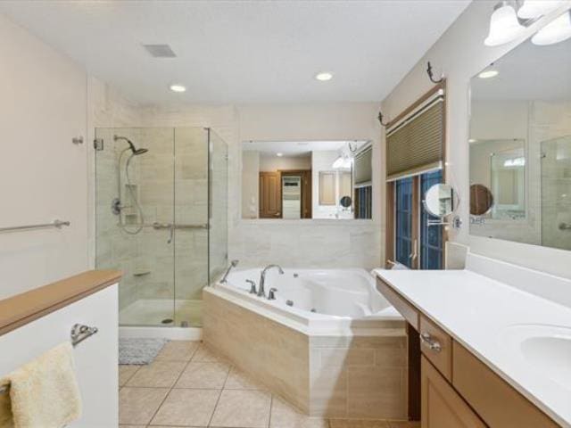 5631 W Spring Knoll Dr, Bay City, MI 48706 - bathroom with a stall shower, a tub with jets, vanity, and tile patterned flooring