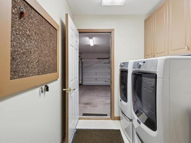 5631 W Spring Knoll Dr, Bay City, MI 48706 - washroom featuring washing machine and dryer and cabinet space