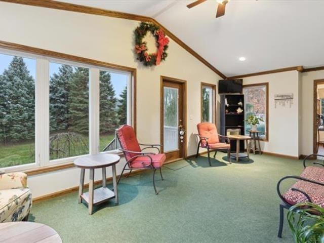 5631 W Spring Knoll Dr, Bay City, MI 48706 - living area featuring baseboards, crown molding, vaulted ceiling, healthy amount of natural light, and carpet