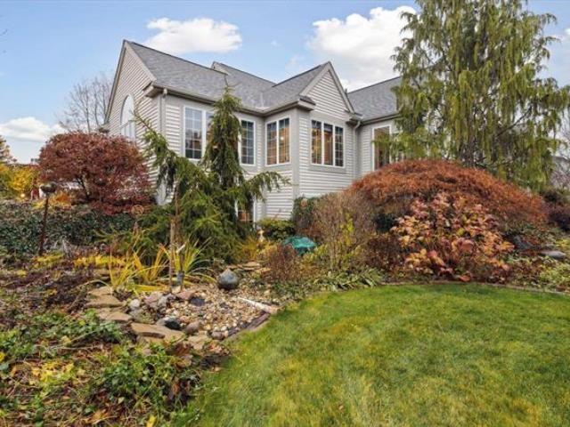 5631 W Spring Knoll Dr, Bay City, MI 48706 - view of side of home featuring a lawn