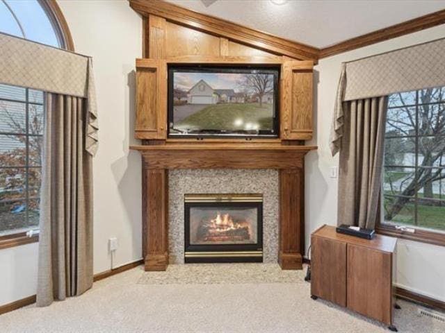 5631 W Spring Knoll Dr, Bay City, MI 48706 - detailed view of carpet flooring, ornamental molding, baseboards, and a glass covered fireplace