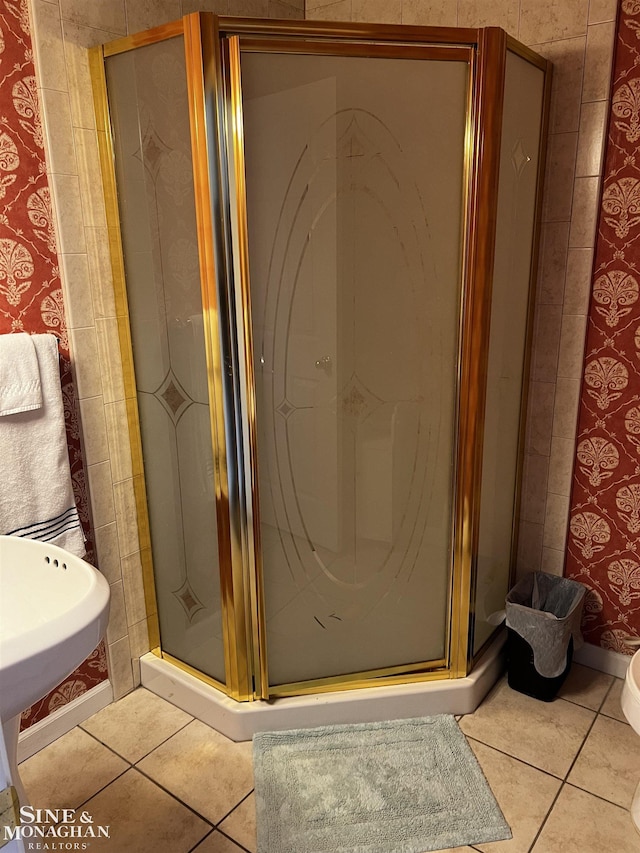 2740 River Rd, Marysville, MI 48040 - bathroom featuring tile patterned floors, a stall shower, and toilet