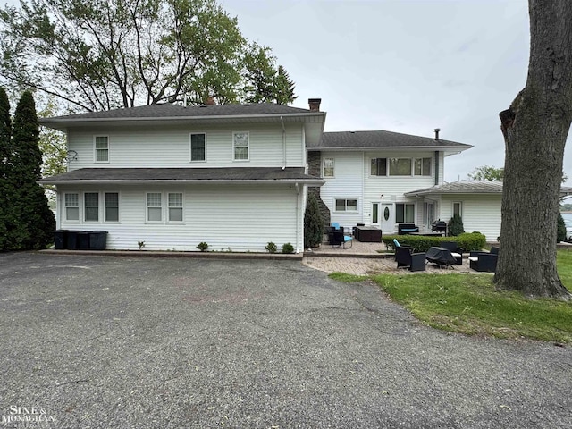 2740 River Rd, Marysville, MI 48040 - back of property featuring a chimney and driveway