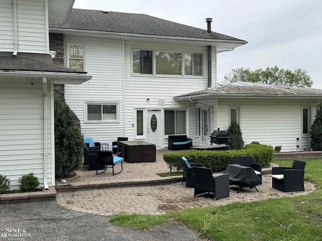 2740 River Rd, Marysville, MI 48040 - rear view of house with a patio area and outdoor lounge area