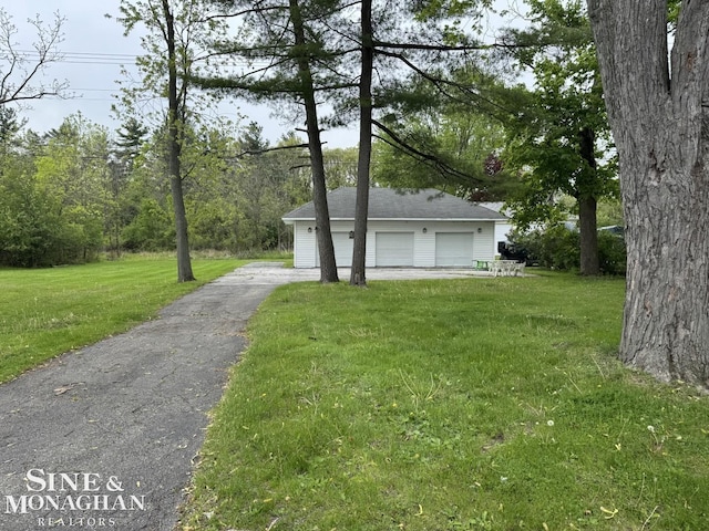 2740 River Rd, Marysville, MI 48040 - view of front of property featuring a detached garage, a front lawn, and an outbuilding
