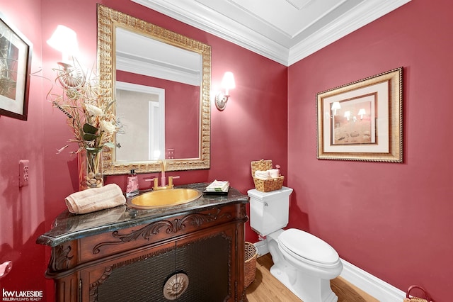 46713 Houghton Dr, Shelby Twp, MI 48315 - bathroom with toilet, wood finished floors, vanity, ornamental molding, and baseboards