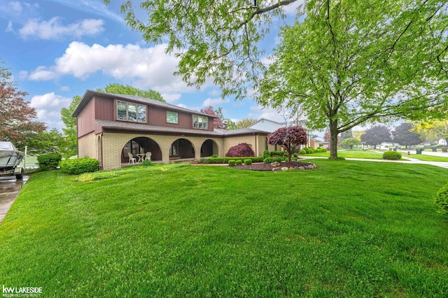 46713 Houghton Dr, Shelby Twp, MI 48315 - view of front of house featuring brick siding and a front lawn