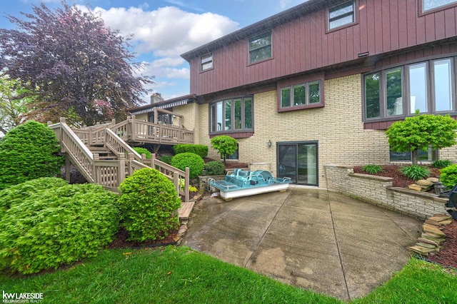 46713 Houghton Dr, Shelby Twp, MI 48315 - back of house featuring a patio, brick siding, a deck, and stairway