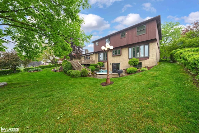 46713 Houghton Dr, Shelby Twp, MI 48315 - back of house with brick siding, a patio area, stairs, and a yard