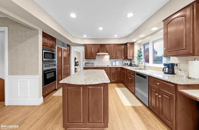 46713 Houghton Dr, Shelby Twp, MI 48315 - kitchen featuring black appliances, a sink, a center island, light wood-type flooring, and custom exhaust hood