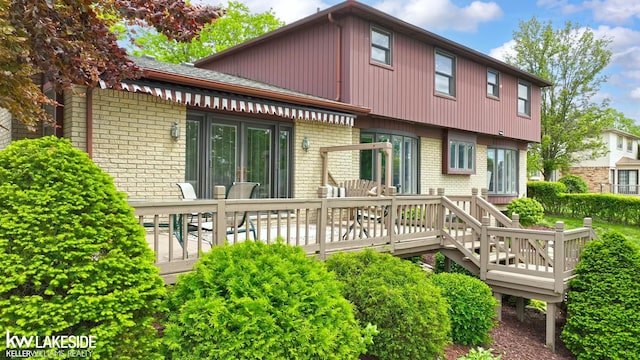 46713 Houghton Dr, Shelby Twp, MI 48315 - rear view of property featuring brick siding and a wooden deck