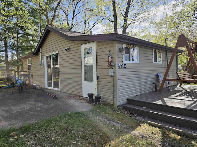 6918 Rumsey Rd, Harrison, MI 48625 - view of property exterior featuring a wooden deck