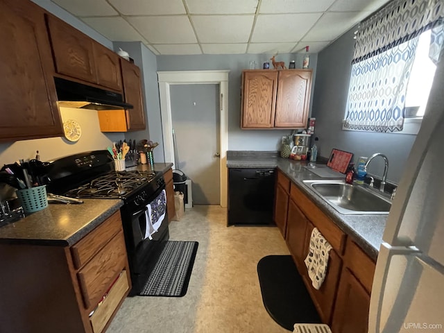 1110 N 2nd St, Ishpeming, MI 49849 - kitchen with black appliances, under cabinet range hood, a drop ceiling, a sink, and dark countertops