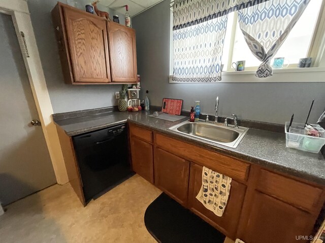 1110 N 2nd St, Ishpeming, MI 49849 - kitchen with dishwasher, a sink, brown cabinetry, and dark countertops