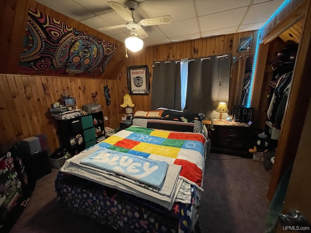 1110 N 2nd St, Ishpeming, MI 49849 - carpeted bedroom with a paneled ceiling, wood walls, and ceiling fan