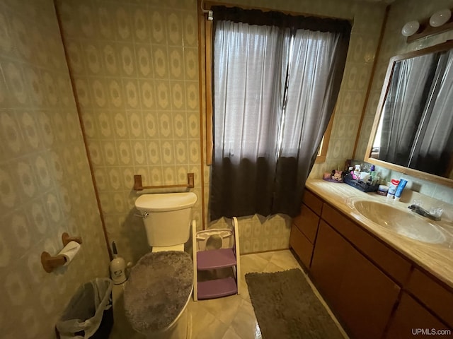 1110 N 2nd St, Ishpeming, MI 49849 - bathroom with vanity, toilet, and tile patterned flooring